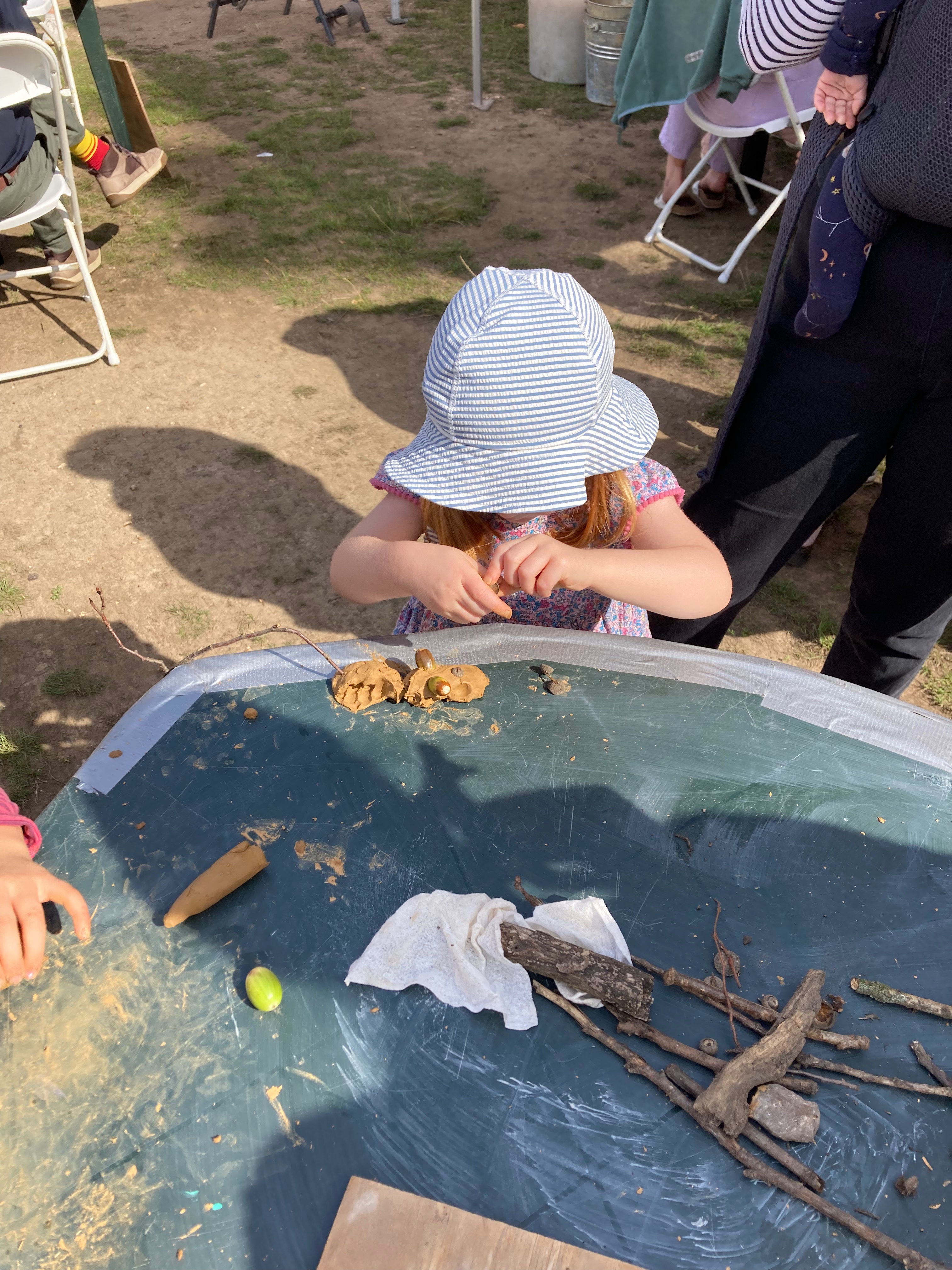 a child making a clay animal