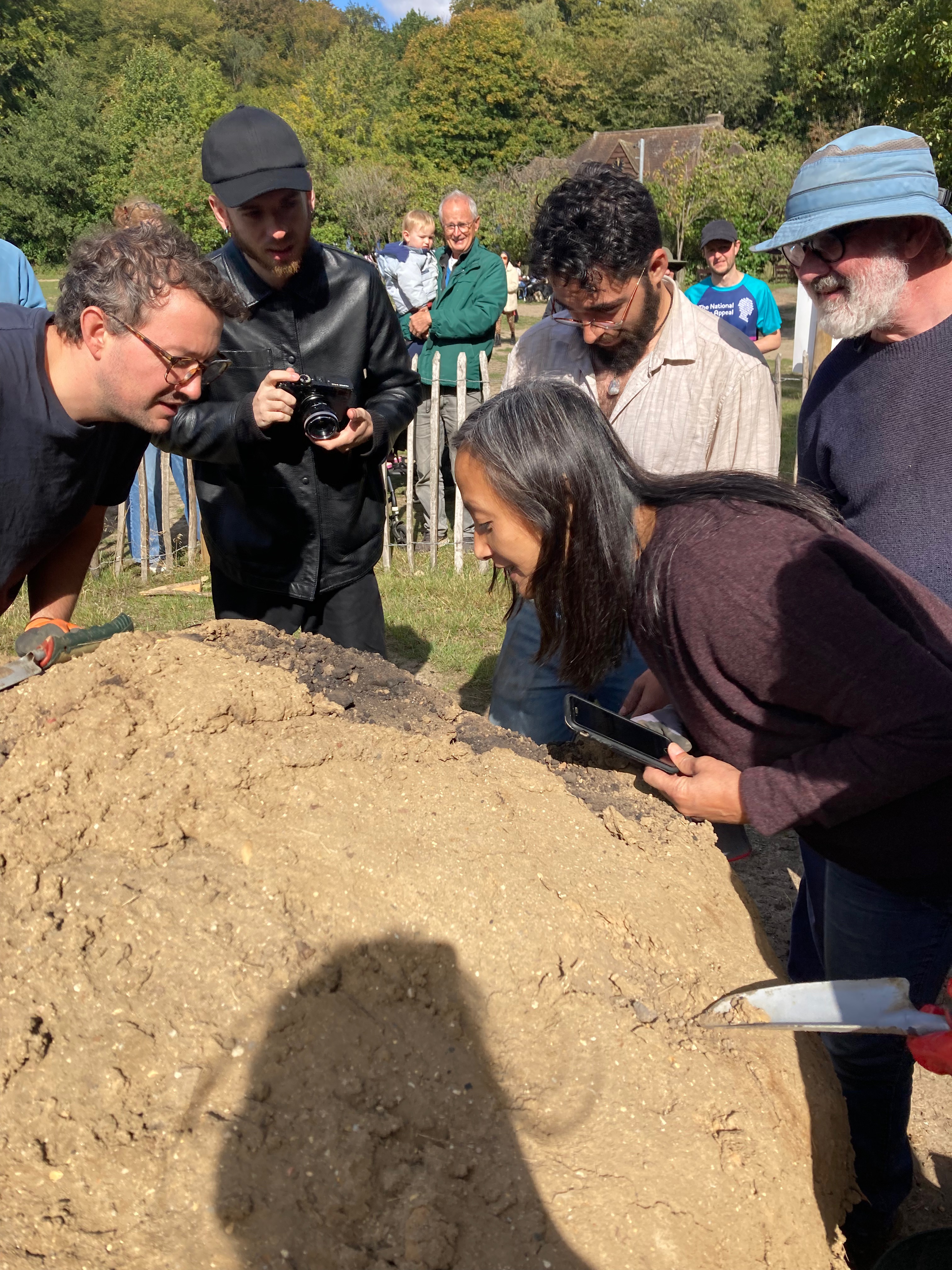 The potters inspect the kiln as it's opened